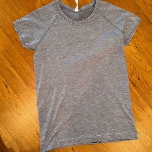 Worn once, like new. Women’s lululemon size 10 swiftly tech short sleeve.
